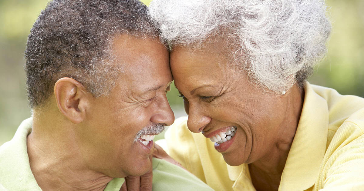 Older black couple in happy embrace