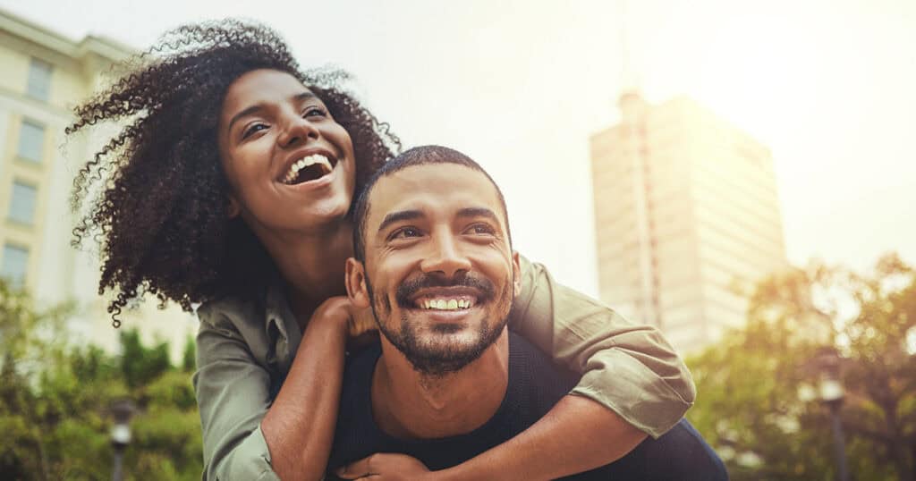 Joyous young black couple outdoors