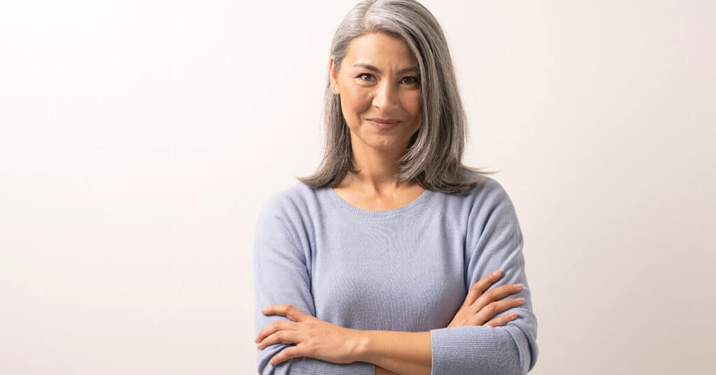 grey-haired woman smiling at camera