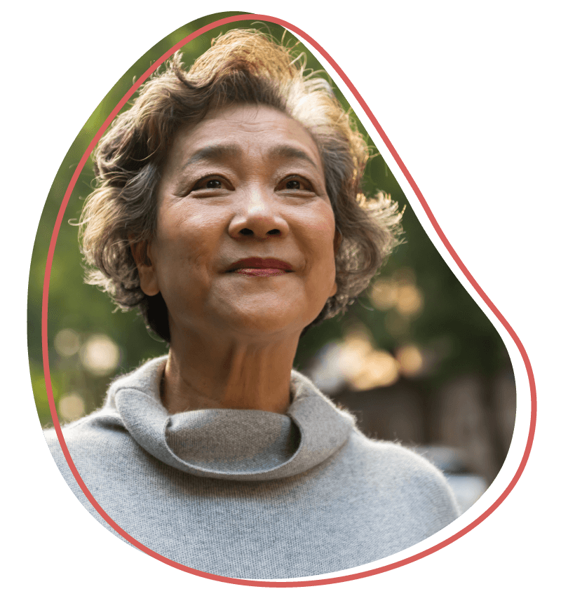 Older short-haired Asian woman looking hopeful