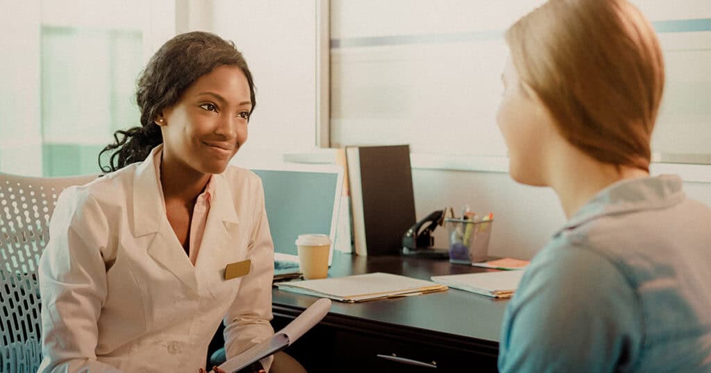 Clinician talking with a patient in office