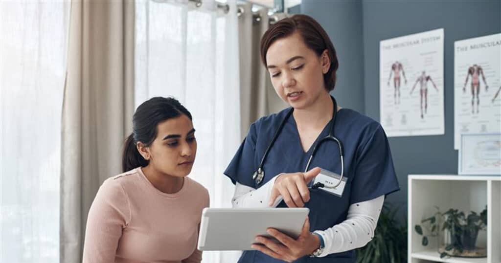 physician showing material on a tablet to patient